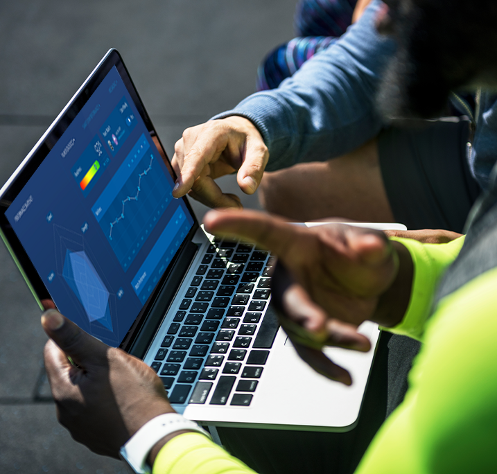 Two people looking at data on laptop